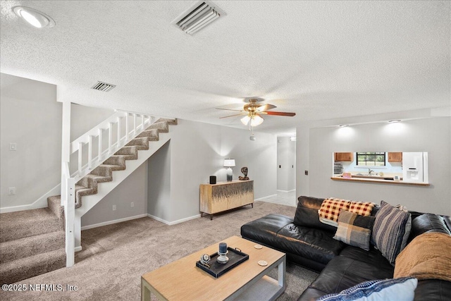 4310 Chokeberry Rd, Middleburg, FL 32068 - carpeted living room featuring stairway, ceiling fan, baseboards, and a textured ceiling