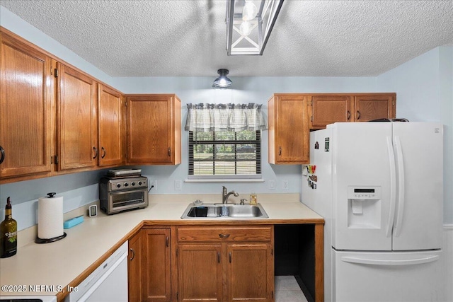 4310 Chokeberry Rd, Middleburg, FL 32068 - kitchen with white appliances, a sink, light countertops, a textured ceiling, and brown cabinets