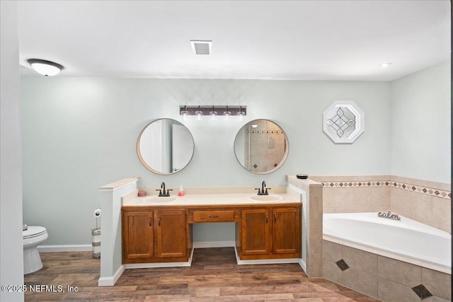 4310 Chokeberry Rd, Middleburg, FL 32068 - full bathroom featuring a garden tub, toilet, double vanity, and wood finished floors