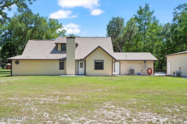 4310 Chokeberry Rd, Middleburg, FL 32068 - rear view of property with central AC, a yard, a chimney, and a shingled roof
