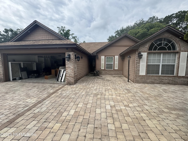 8786 Spring Harvest Ln E, Jacksonville, FL 32244 - view of front of house with brick siding, an attached garage, and decorative driveway