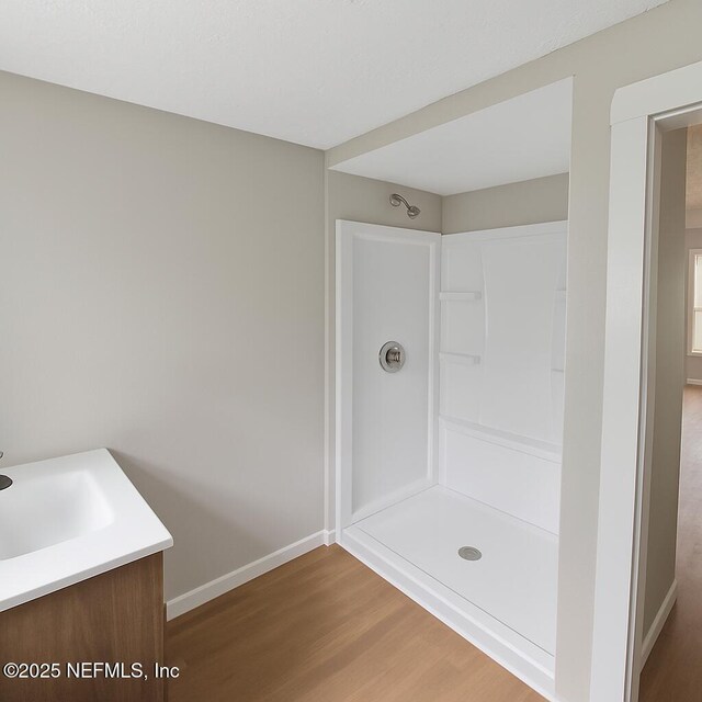 1109 Lake Shore Blvd, Jacksonville, FL 32205 - bathroom featuring baseboards, wood finished floors, a shower, and vanity