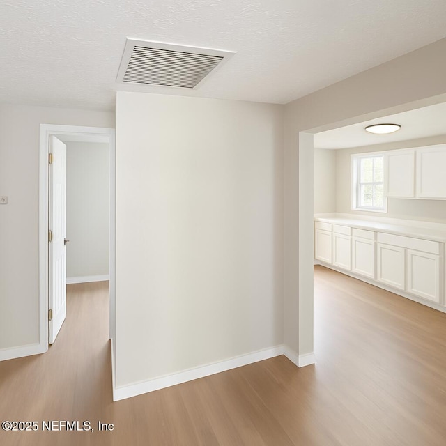 1109 Lake Shore Blvd, Jacksonville, FL 32205 - hall featuring light wood-style flooring, baseboards, and a textured ceiling