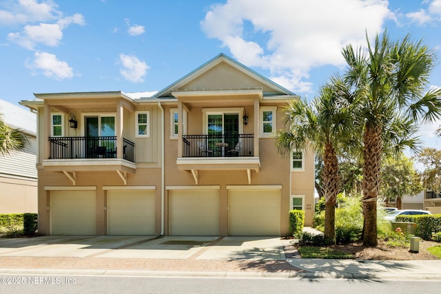 95282 Summerwoods Cir Unit 608, Fernandina Beach, FL 32034 - view of property with driveway, a balcony, stucco siding, and an attached garage
