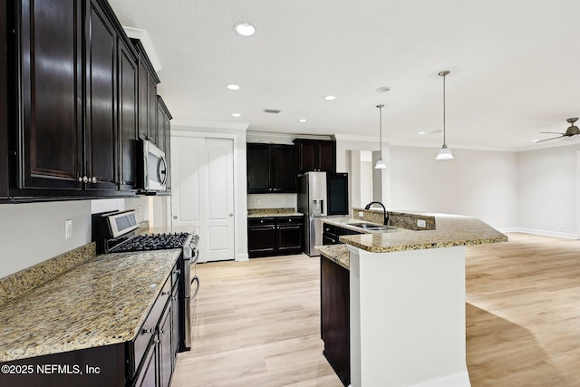 124 Medio Dr, Saint Augustine, FL 32095 - kitchen featuring appliances with stainless steel finishes, a sink, light wood-style floors, ornamental molding, and hanging light fixtures