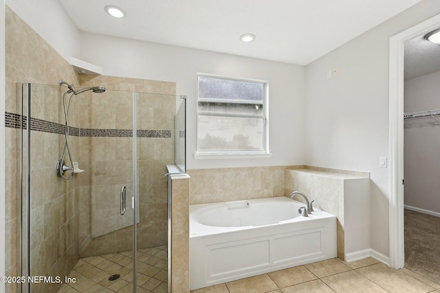 124 Medio Dr, Saint Augustine, FL 32095 - bathroom featuring a bath, a shower stall, tile patterned flooring, a spacious closet, and recessed lighting