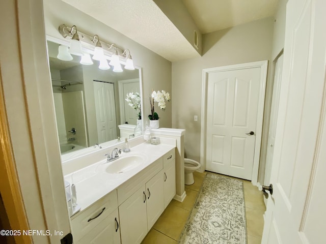 bathroom with toilet, tile patterned flooring, vanity, and washtub / shower combination
