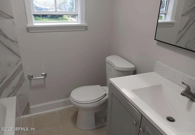 bathroom with toilet, tile patterned flooring, and vanity