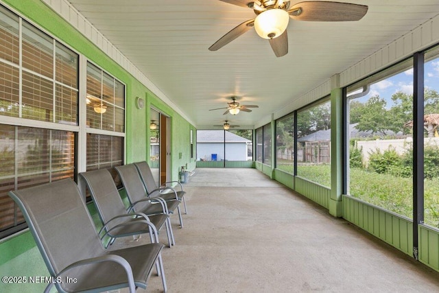sunroom / solarium featuring ceiling fan