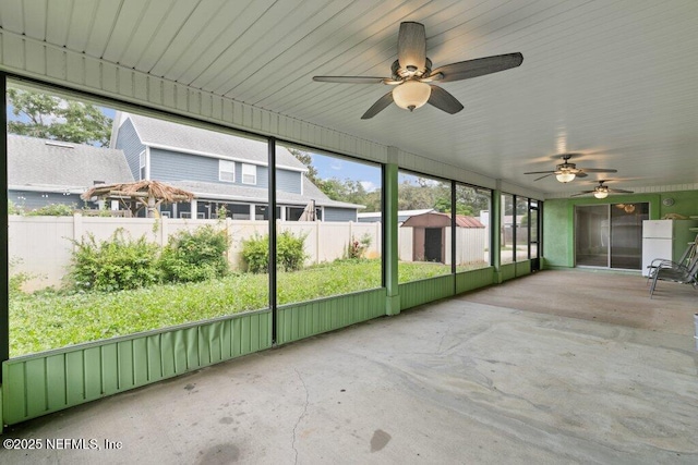 unfurnished sunroom with ceiling fan and plenty of natural light