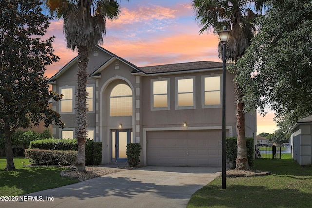 76466 Long Leaf Loop, Yulee, FL 32097 - view of front of property featuring an attached garage, stucco siding, driveway, and roof with shingles