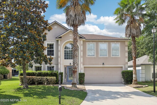 76466 Long Leaf Loop, Yulee, FL 32097 - traditional-style home with an attached garage, driveway, stucco siding, and a front lawn