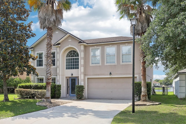 76466 Long Leaf Loop, Yulee, FL 32097 - view of front of house with an attached garage, driveway, and stucco siding