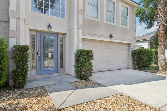 76466 Long Leaf Loop, Yulee, FL 32097 - entrance to property with an attached garage, stucco siding, and driveway