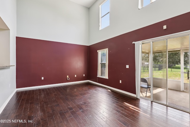 76466 Long Leaf Loop, Yulee, FL 32097 - spare room featuring hardwood / wood-style flooring, a towering ceiling, and baseboards