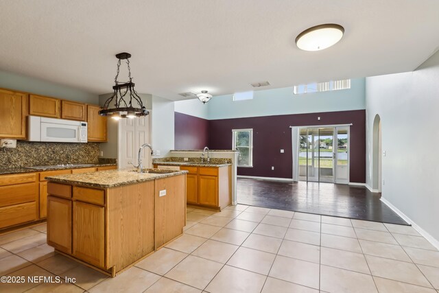 76466 Long Leaf Loop, Yulee, FL 32097 - kitchen with white appliances, a sink, light tile patterned floors, light stone countertops, and decorative backsplash