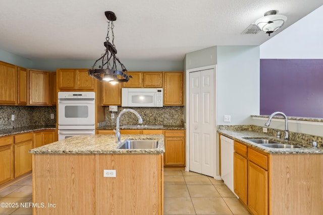 76466 Long Leaf Loop, Yulee, FL 32097 - kitchen with white appliances, a sink, and light tile patterned floors