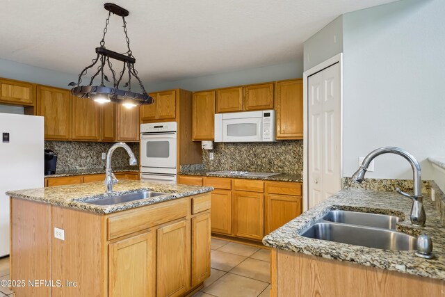 76466 Long Leaf Loop, Yulee, FL 32097 - kitchen with a sink, white appliances, decorative backsplash, and light stone counters