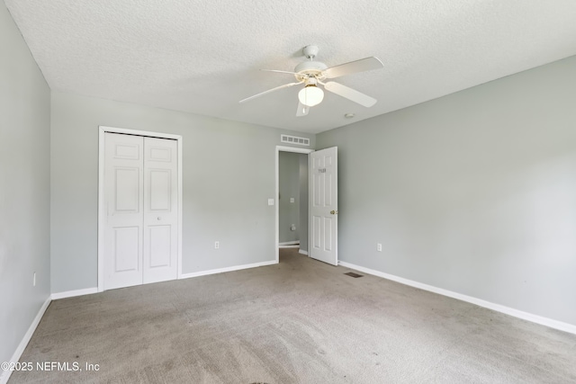 76466 Long Leaf Loop, Yulee, FL 32097 - unfurnished bedroom with a closet, carpet floors, baseboards, and a textured ceiling