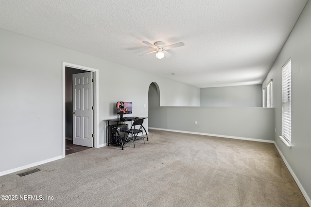 76466 Long Leaf Loop, Yulee, FL 32097 - carpeted spare room with a ceiling fan, arched walkways, a textured ceiling, and baseboards