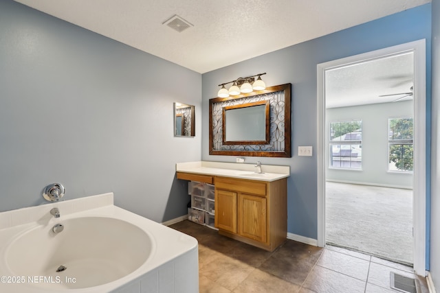 76466 Long Leaf Loop, Yulee, FL 32097 - full bath featuring a bath, vanity, tile patterned flooring, baseboards, and a textured ceiling
