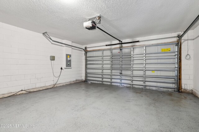 76466 Long Leaf Loop, Yulee, FL 32097 - garage featuring electric panel, a garage door opener, and concrete block wall