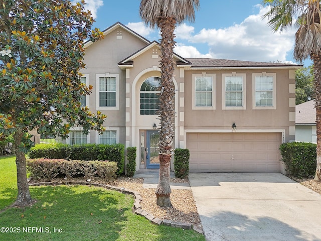 76466 Long Leaf Loop, Yulee, FL 32097 - view of front facade featuring stucco siding, driveway, a garage, and a front yard