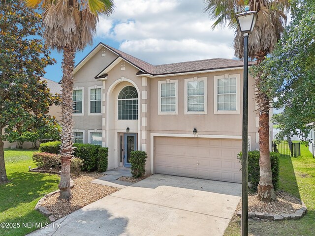 76466 Long Leaf Loop, Yulee, FL 32097 - traditional home with stucco siding, an attached garage, and concrete driveway