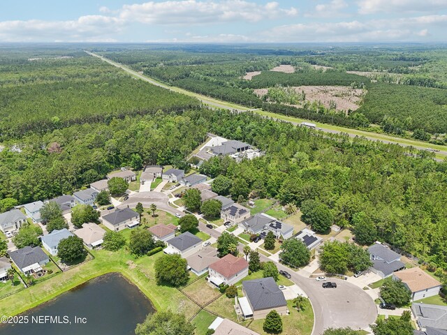 76466 Long Leaf Loop, Yulee, FL 32097 - aerial view of property's location with a heavily wooded area, a nearby body of water, and nearby suburban area