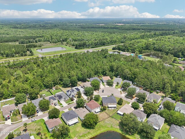 76466 Long Leaf Loop, Yulee, FL 32097 - aerial view of property and surrounding area featuring a heavily wooded area, a large body of water, and nearby suburban area