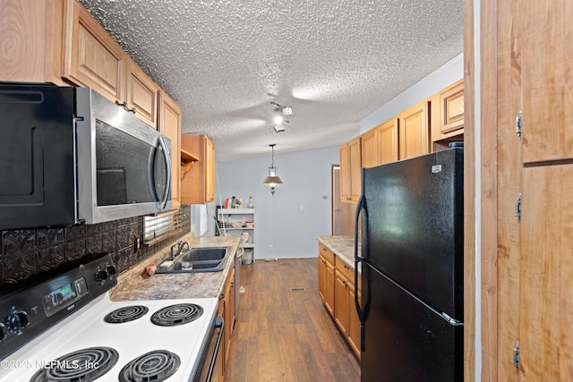 112 Sculpin Dr, Florahome, FL 32140 - kitchen with freestanding refrigerator, electric stove, a sink, stainless steel microwave, and dark wood-type flooring