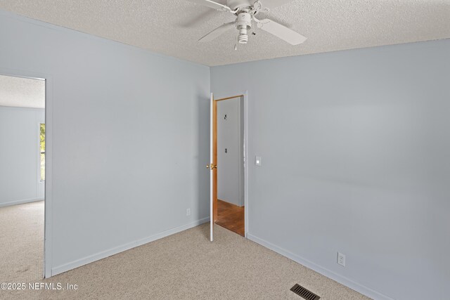 112 Sculpin Dr, Florahome, FL 32140 - spare room with carpet flooring, a textured ceiling, ceiling fan, and baseboards