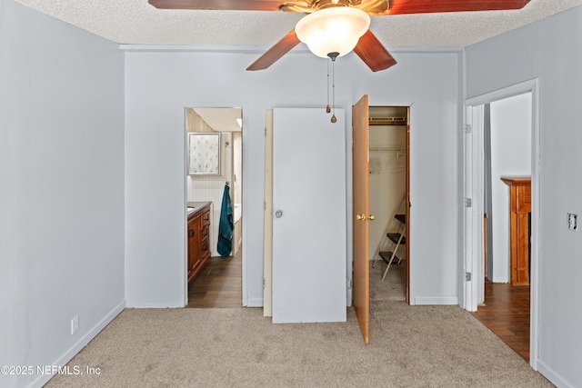 112 Sculpin Dr, Florahome, FL 32140 - unfurnished bedroom with carpet, a walk in closet, a closet, a textured ceiling, and ceiling fan