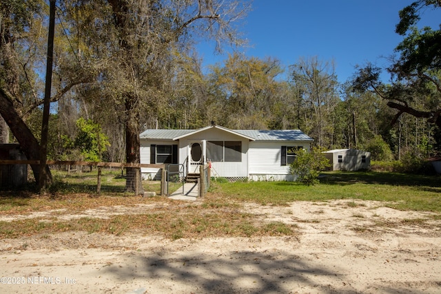 112 Sculpin Dr, Florahome, FL 32140 - manufactured / mobile home featuring metal roof, fence, and a sunroom