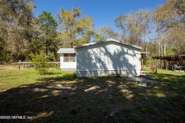 112 Sculpin Dr, Florahome, FL 32140 - view of property exterior with a lawn and a sunroom