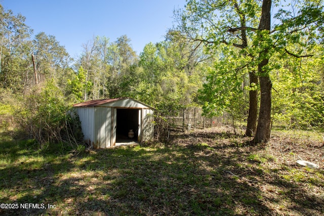 112 Sculpin Dr, Florahome, FL 32140 - view of shed featuring a wooded view and fence