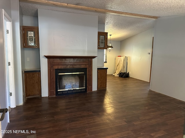 112 Sculpin Dr, Florahome, FL 32140 - unfurnished living room featuring a textured ceiling, dark wood-type flooring, and a glass covered fireplace