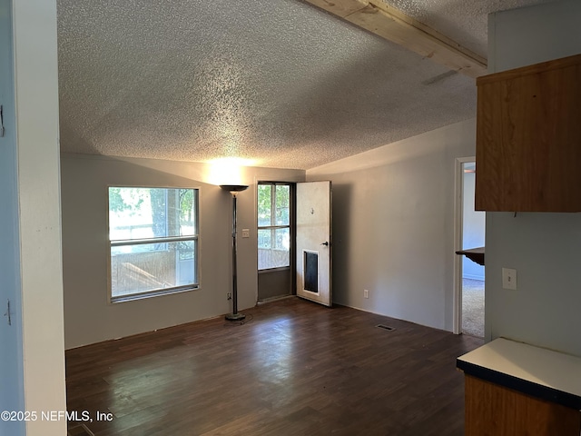112 Sculpin Dr, Florahome, FL 32140 - unfurnished living room featuring a textured ceiling, dark wood finished floors, and beamed ceiling