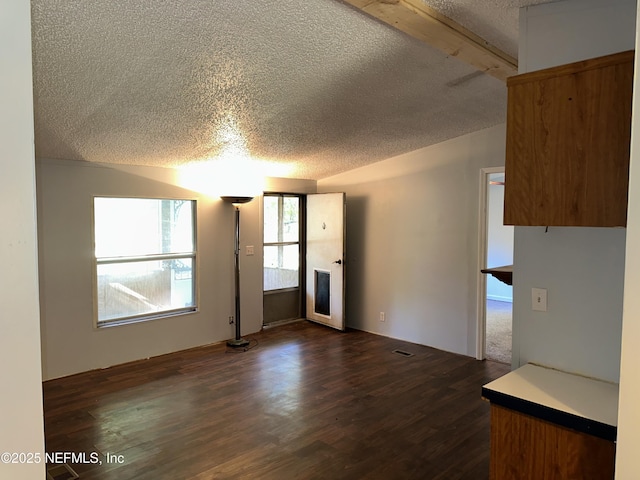 112 Sculpin Dr, Florahome, FL 32140 - unfurnished living room featuring a textured ceiling and dark wood-type flooring