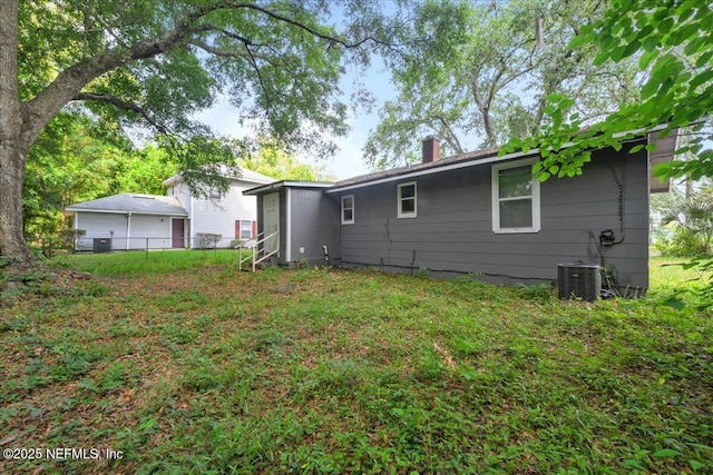 2058 W 40th St, Jacksonville, FL 32209 - rear view of house with a chimney, fence, and cooling unit