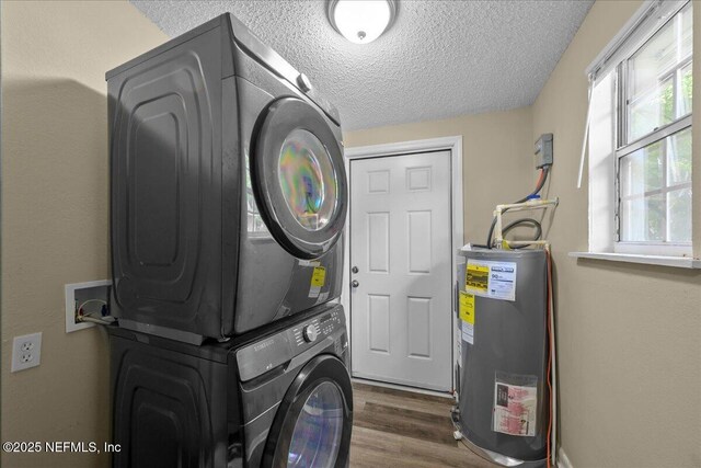 2058 W 40th St, Jacksonville, FL 32209 - laundry area with water heater, stacked washing machine and dryer, a textured ceiling, and dark wood-style flooring