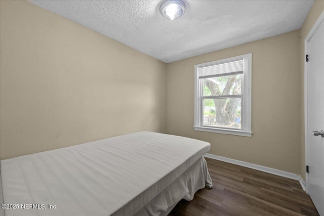 2058 W 40th St, Jacksonville, FL 32209 - bedroom featuring dark wood finished floors, baseboards, and a textured ceiling