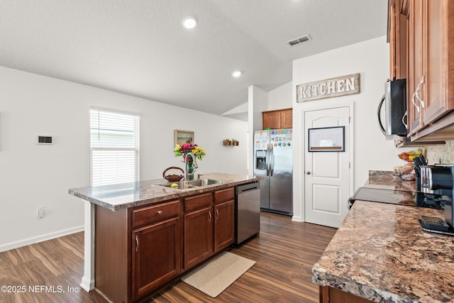 2840 Buck Creek Pl, Green Cove Springs, FL 32043 - kitchen featuring appliances with stainless steel finishes, a sink, lofted ceiling, a kitchen island with sink, and dark wood-style floors