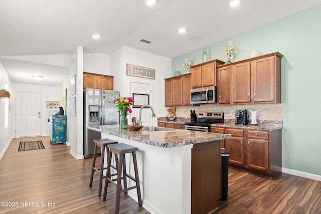 2840 Buck Creek Pl, Green Cove Springs, FL 32043 - kitchen featuring stainless steel appliances, a sink, decorative backsplash, a kitchen island with sink, and dark wood-style floors