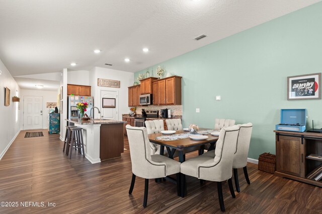 2840 Buck Creek Pl, Green Cove Springs, FL 32043 - dining space featuring dark wood-style flooring, lofted ceiling, baseboards, and recessed lighting