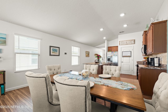 2840 Buck Creek Pl, Green Cove Springs, FL 32043 - dining space with lofted ceiling, light wood-style flooring, recessed lighting, baseboards, and a textured ceiling