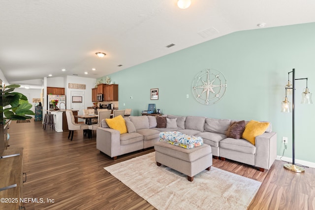 2840 Buck Creek Pl, Green Cove Springs, FL 32043 - living room featuring lofted ceiling, dark wood-style flooring, and recessed lighting