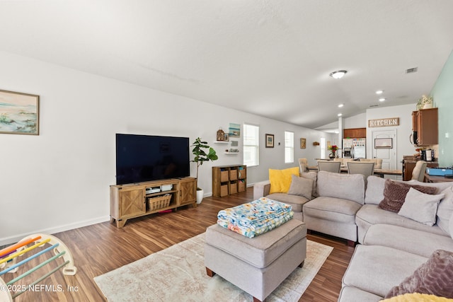 2840 Buck Creek Pl, Green Cove Springs, FL 32043 - living area with vaulted ceiling, wood finished floors, and baseboards