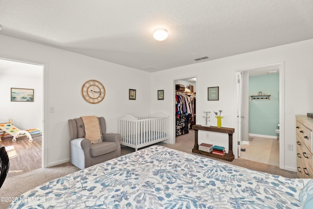 2840 Buck Creek Pl, Green Cove Springs, FL 32043 - bedroom featuring carpet flooring, a spacious closet, a textured ceiling, baseboards, and ensuite bathroom