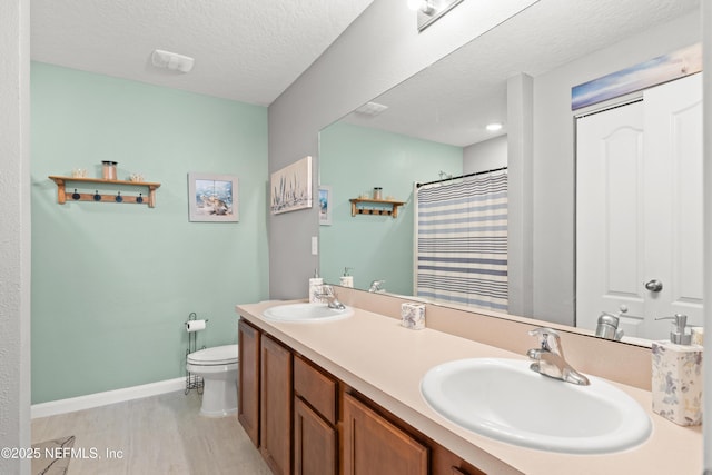 2840 Buck Creek Pl, Green Cove Springs, FL 32043 - bathroom with toilet, baseboards, double vanity, a shower with shower curtain, and a textured ceiling